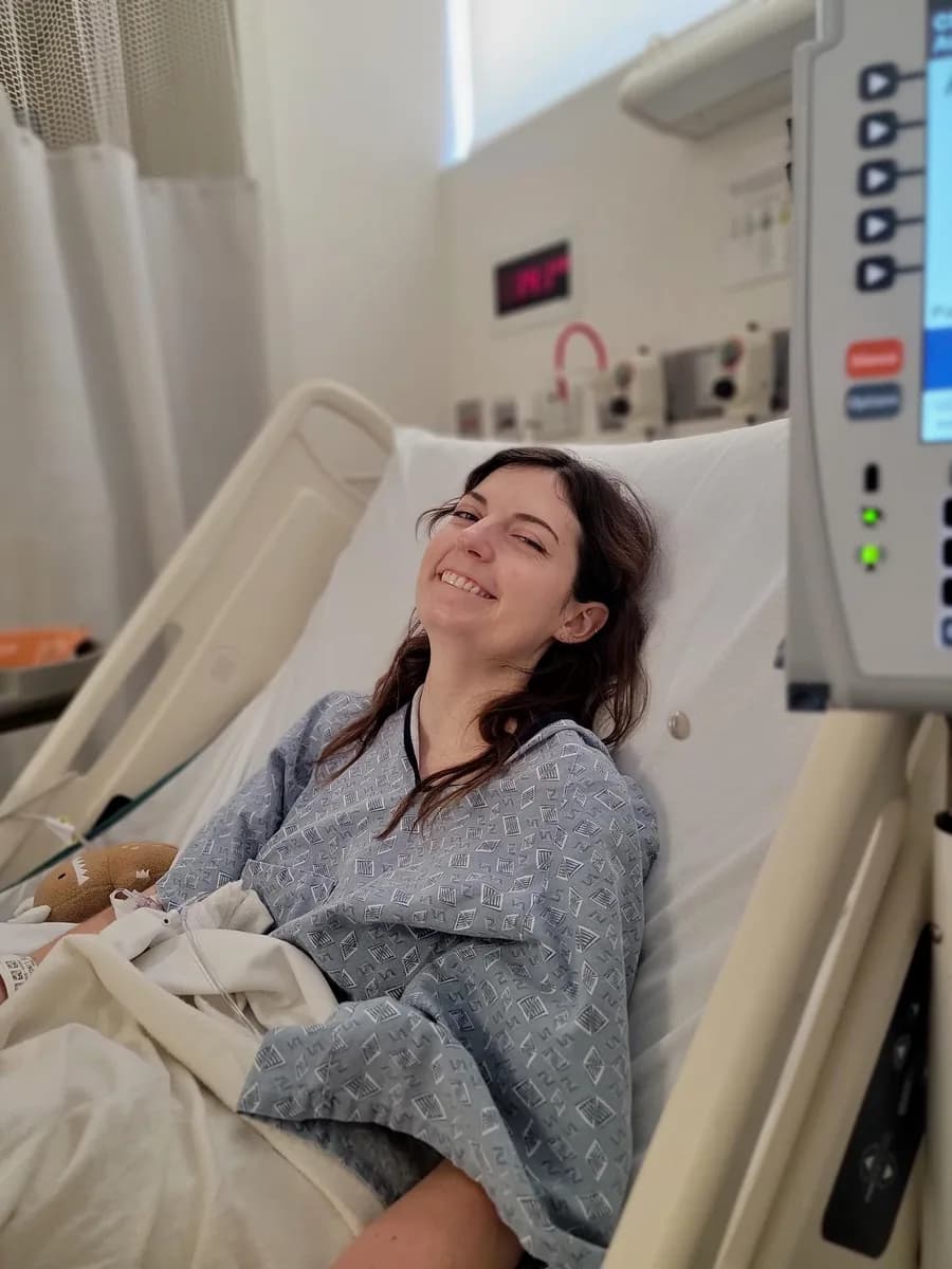 Charlotte smiling in a hospital bed.